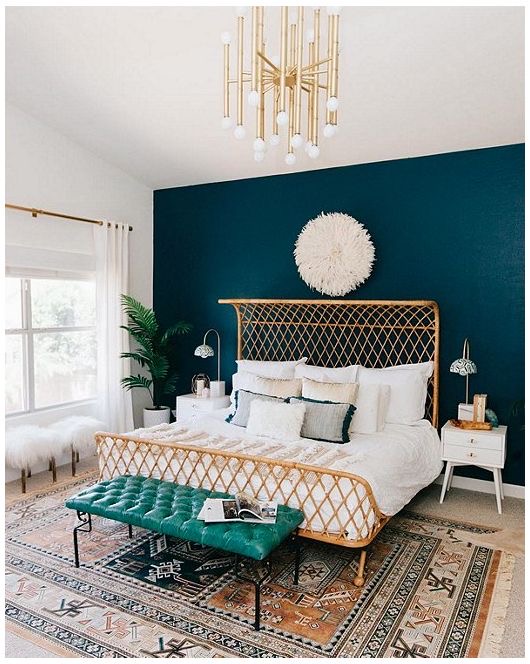 Bedroom with single teal-painted accent wall behind a rattan bed — the simplest DIY accent wall idea using only paint.