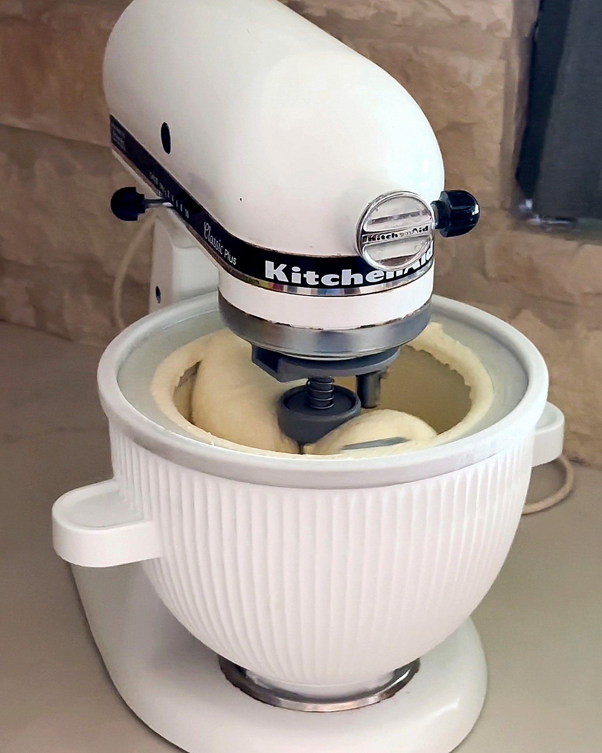 KitchenAid stand mixer ice cream attachment churning homemade vanilla ice cream in its frozen bowl