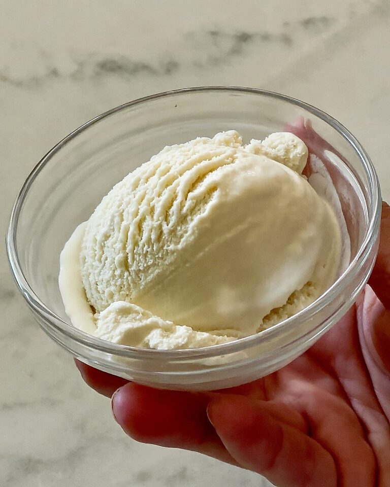 Bowl of creamy homemade vanilla ice cream made with clean ingredients and no refined sugar