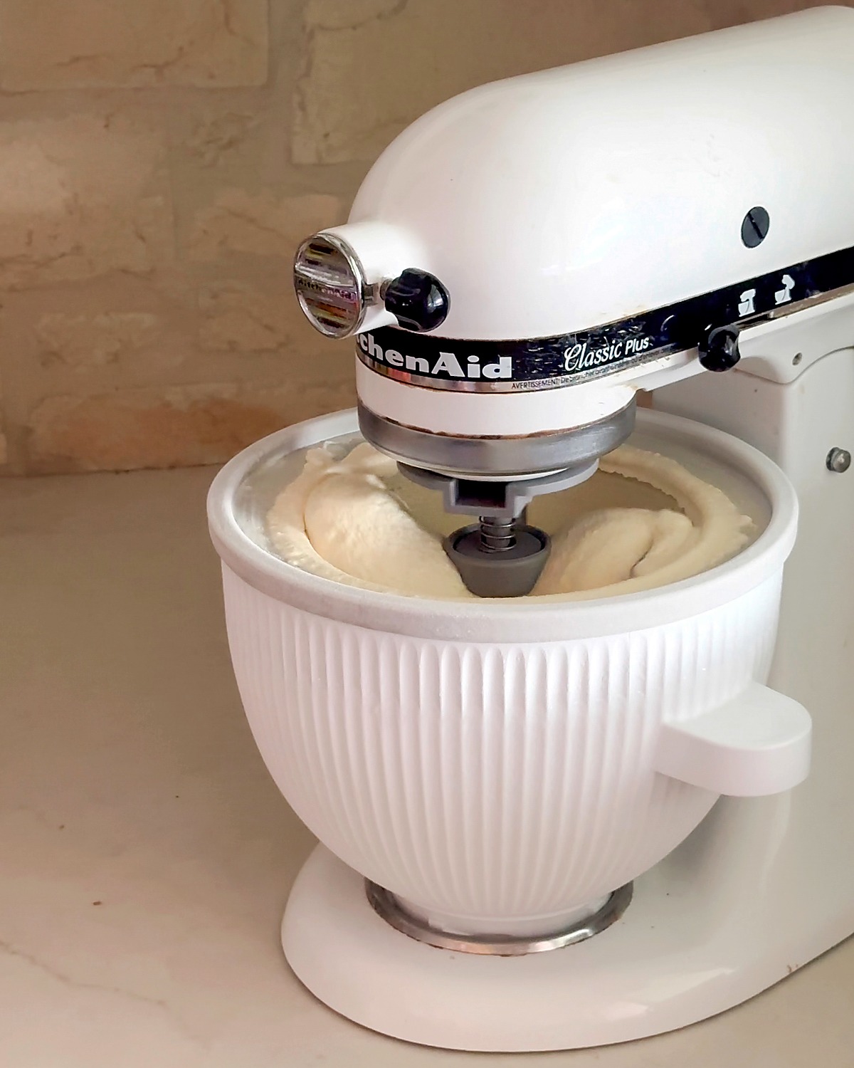 Finished homemade vanilla ice cream churned in the KitchenAid ice cream attachment bowl