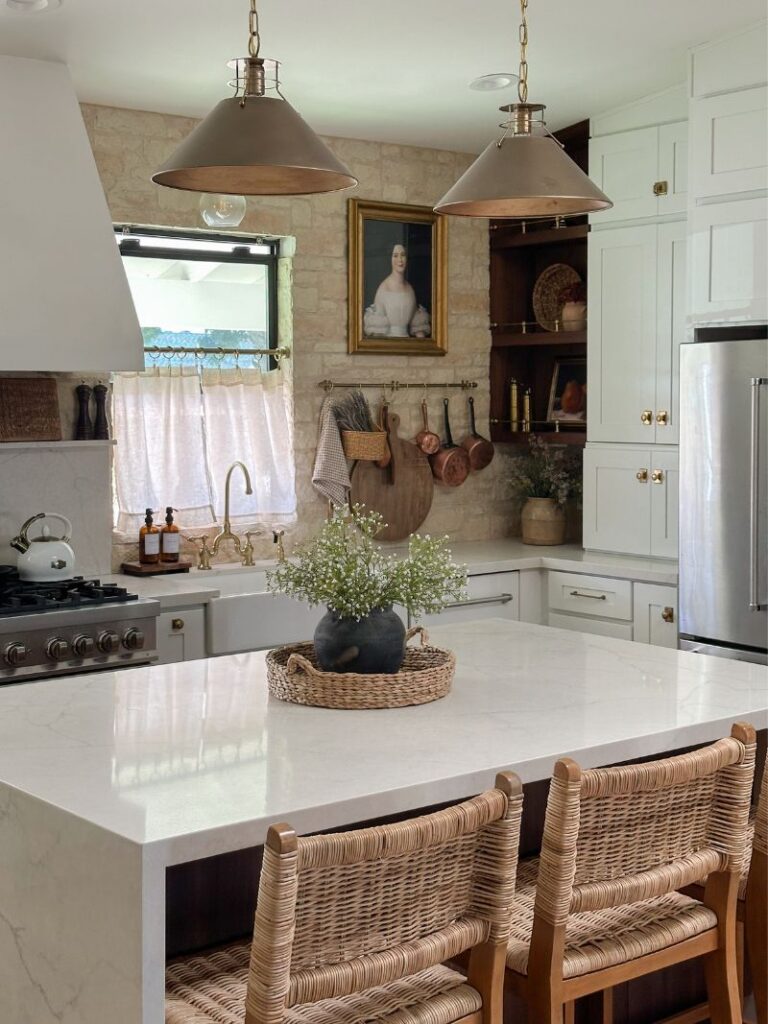 The Adobe Project kitchen renovation with brick backsplash, brass pendant lights, and white marble island