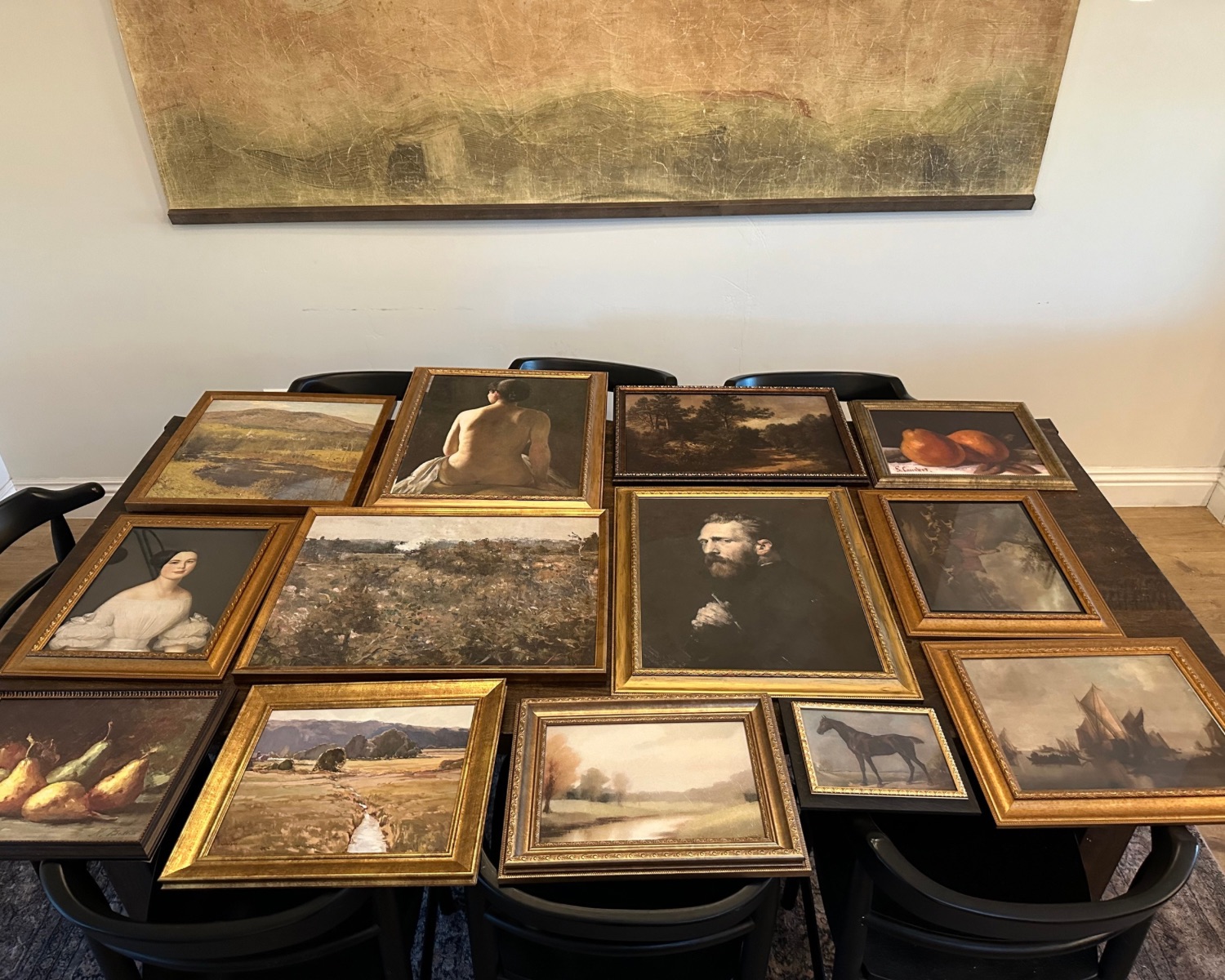 gallery wall layout planning with ornate frames on a table