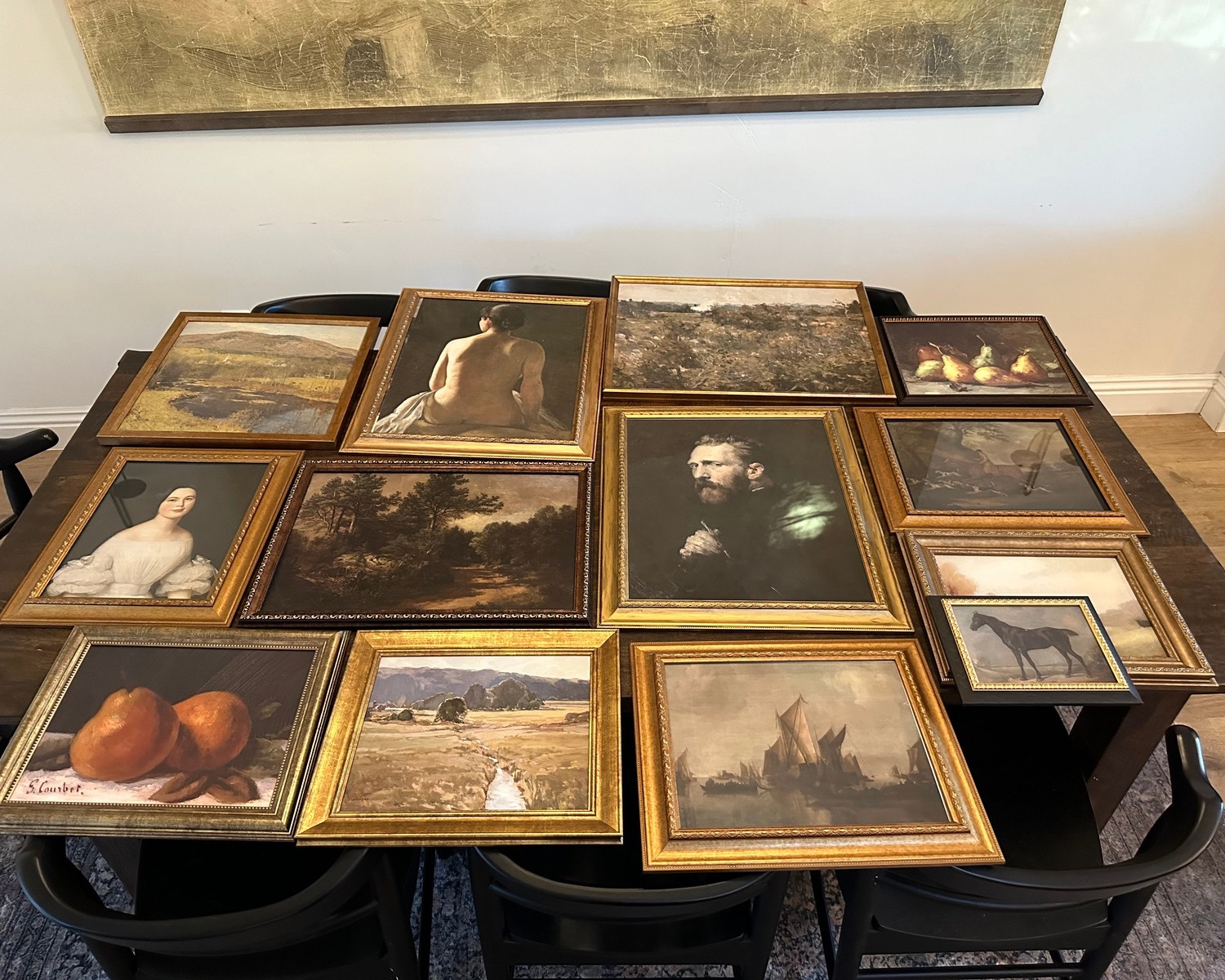 artwork in ornate frames laying on a table