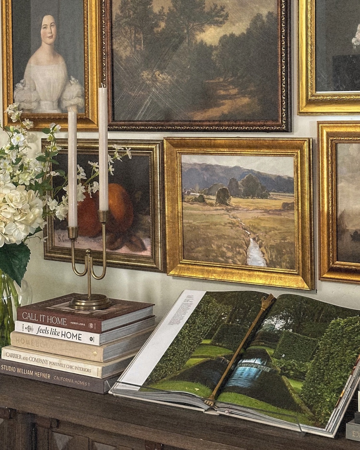 close of up coffee table book displayed on credenza and gallery wall