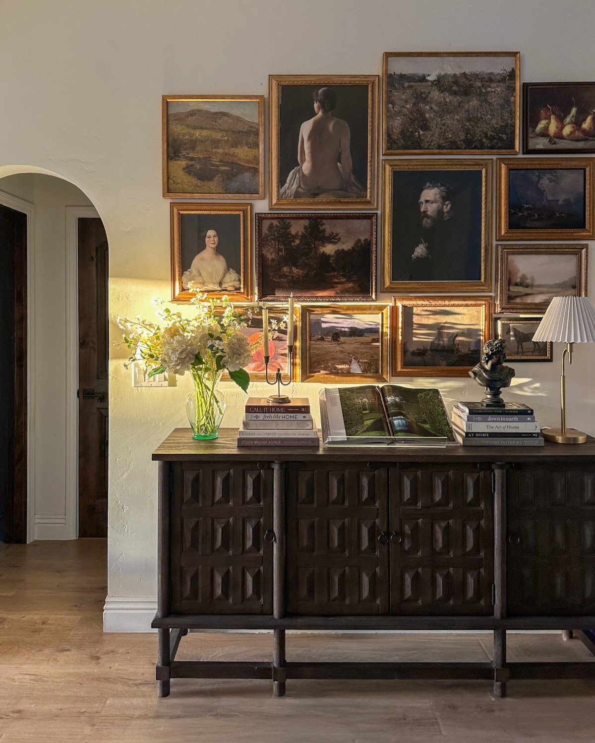 sunlit gallery wall with dark wood sideboard table